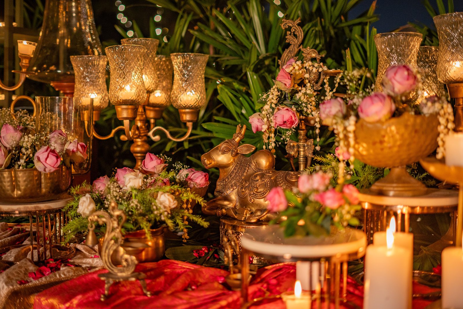 Daawat by Pappadh — brass Nandi, roses and hurricane lamps