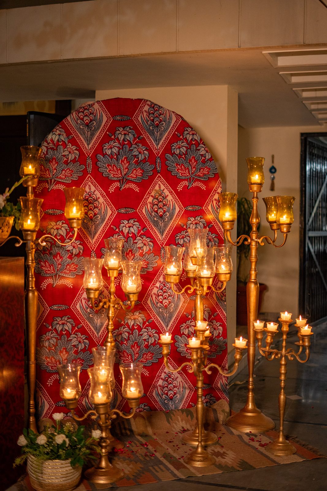Daawat by Pappadh — block-print arch backdrop with brass candelabras